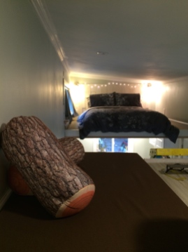 storage loft with my favorite log pillows and handmade cushion